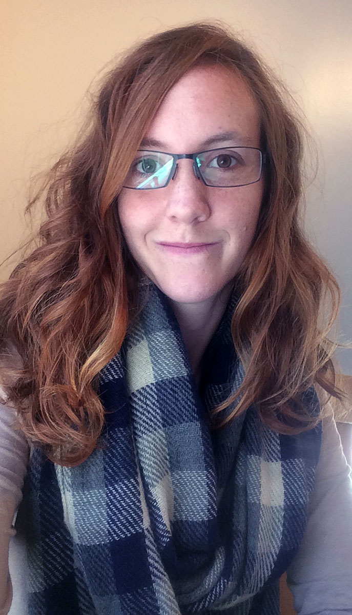 portrait photograph of Haley Hopper wearing glasses and a soft smile